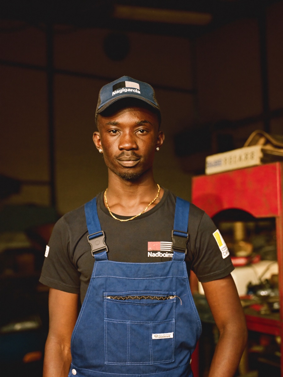 A young auto mechanic in his workshop