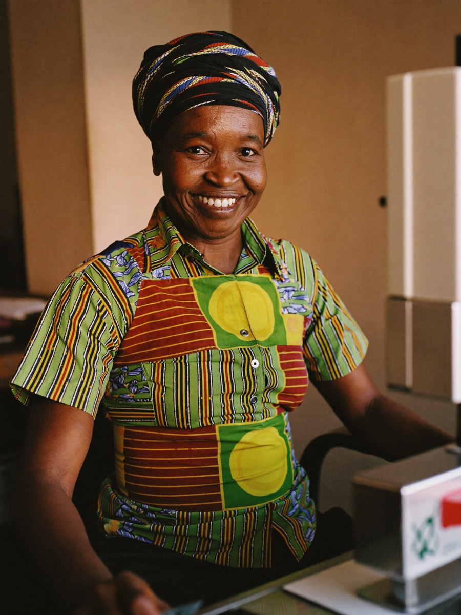 A tailor smiling in her shop